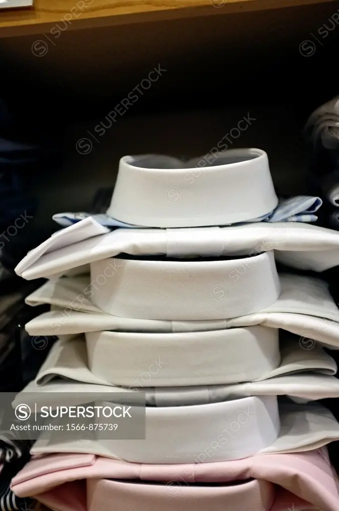 Stack of Men´s White Dress Shirts Displayed in a Retail Clothing Store