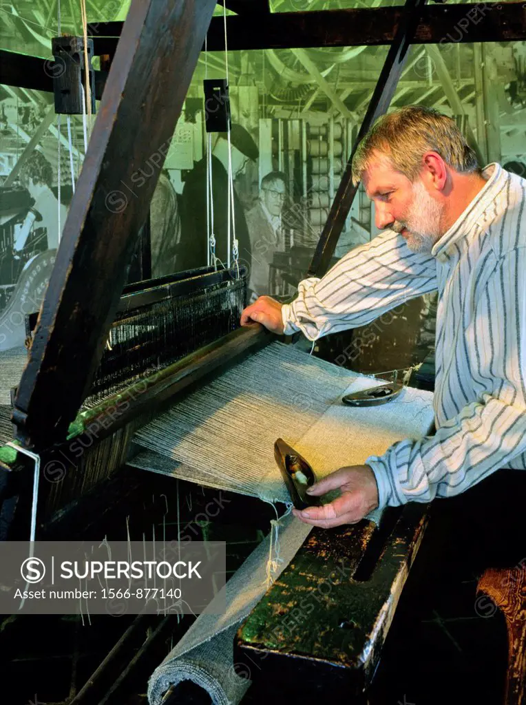 Staff demonstrate handloom weaving in Museum of the Welsh Woollen Industry at Dre-Fach Felindre in the Dyfed region of Wales, UK