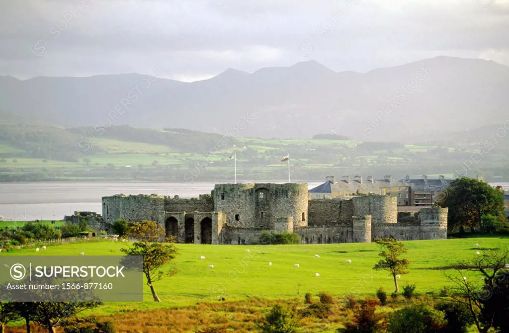 Beaumaris Castle, Anglesey, north Wales, UK with Menai Strait and mountains of Snowdonia behind