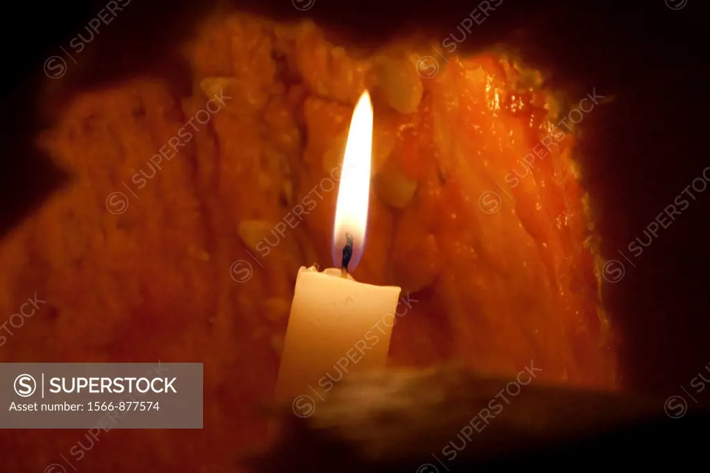 A lit candle inside a Jack O´lantern