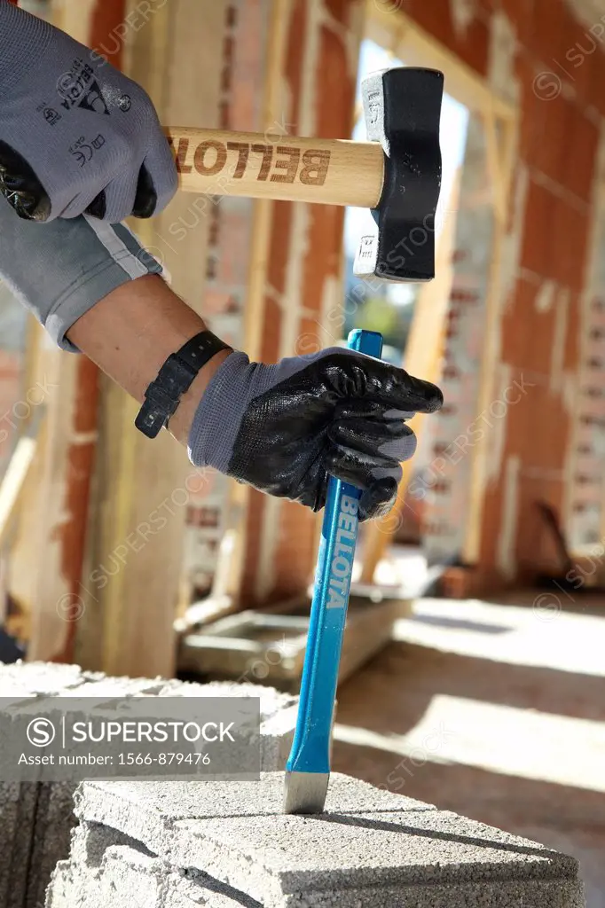 Construction worker with sledgehammer and chisel, Building hand tool, Donostia, San Sebastian, Gipuzkoa, Basque Country, Spain