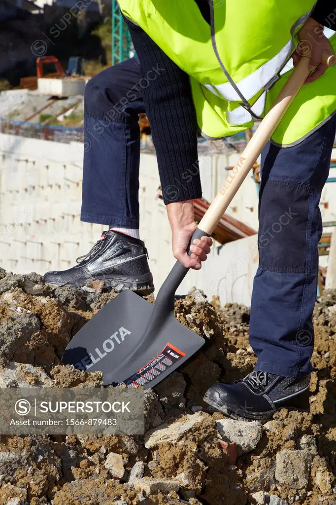 Construction worker with a shovel, Building hand tool, Donostia, San Sebastian, Gipuzkoa, Basque Country, Spain