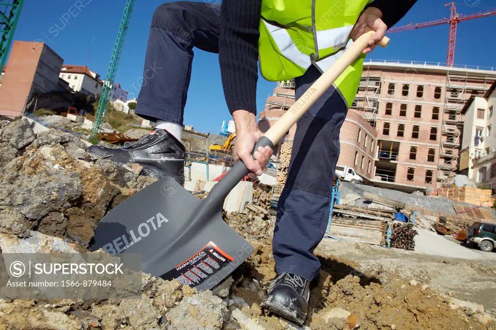 Construction worker with a shovel, Building hand tool, Donostia, San Sebastian, Gipuzkoa, Basque Country, Spain
