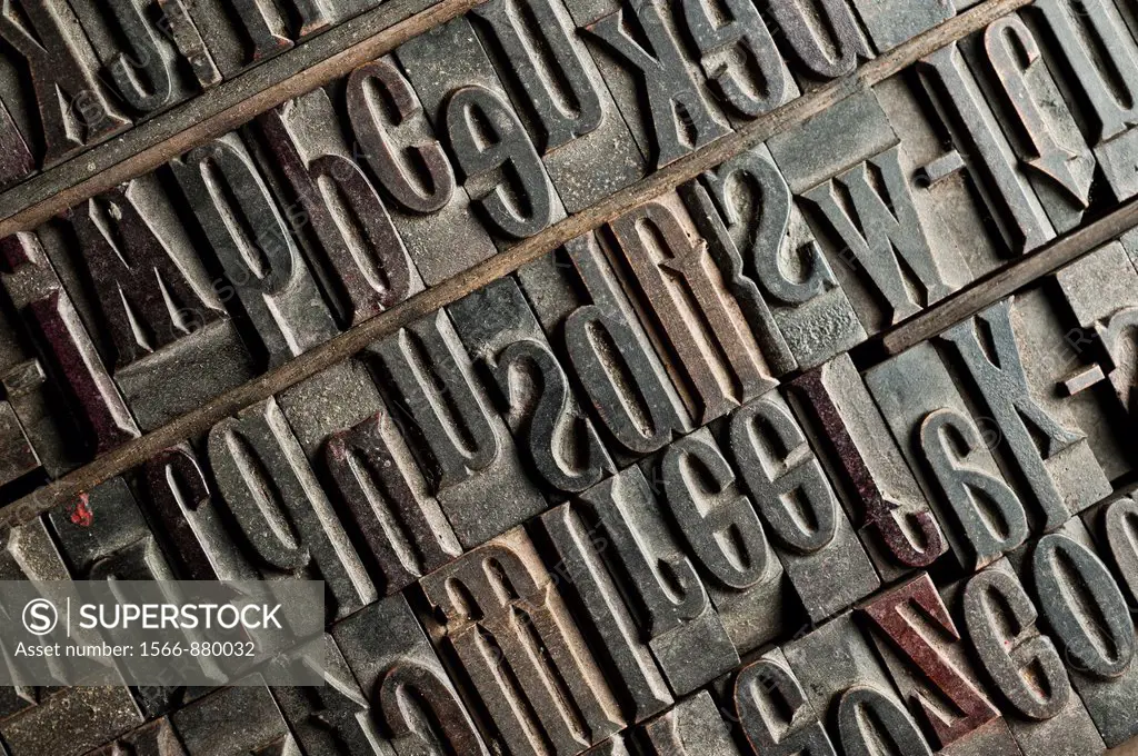 a tray of carved wooden letters, part of a letterpress set