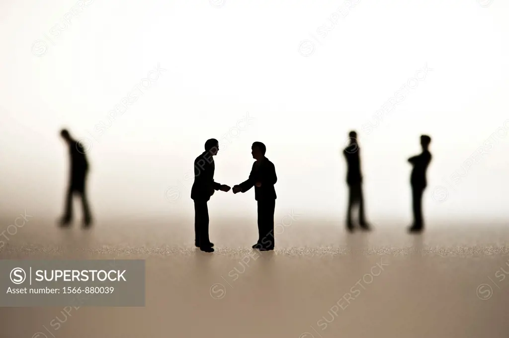 silhouetted small figures conceptual image for business men meeting
