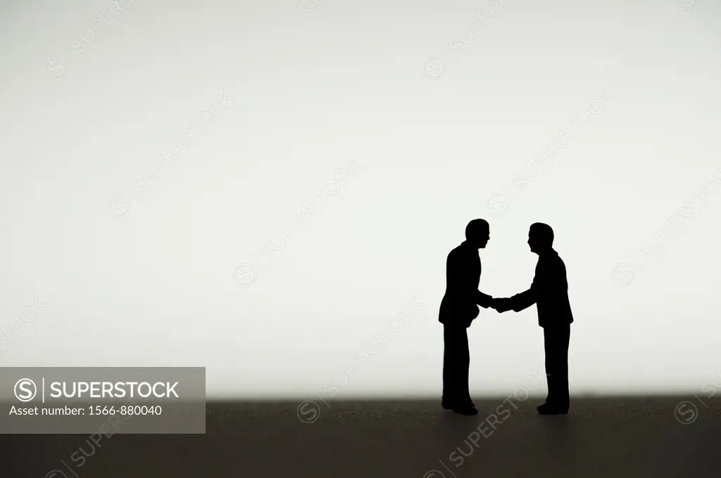 silhouetted small figures conceptual image for business men meeting