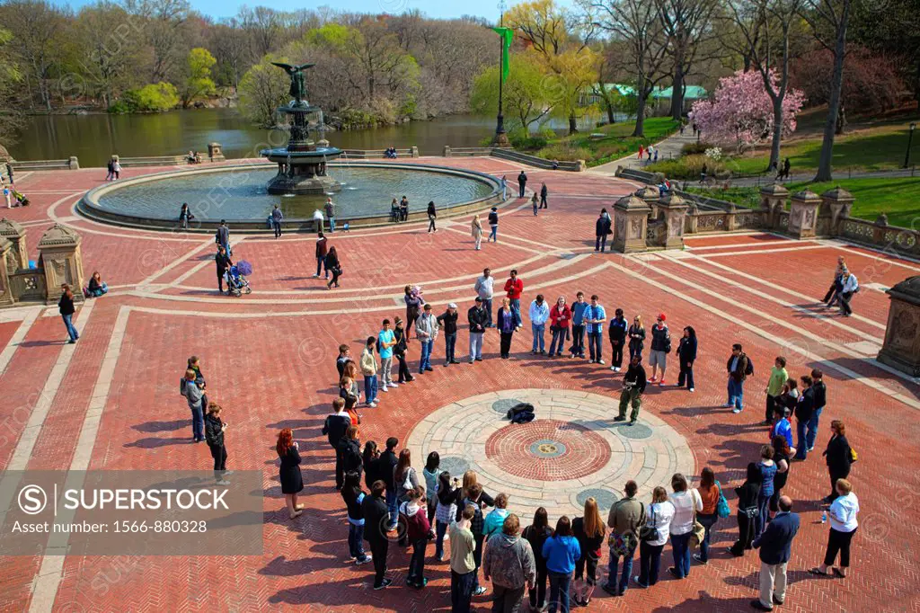 A circle of people forms around Saxophone player on Bethesda Terrace