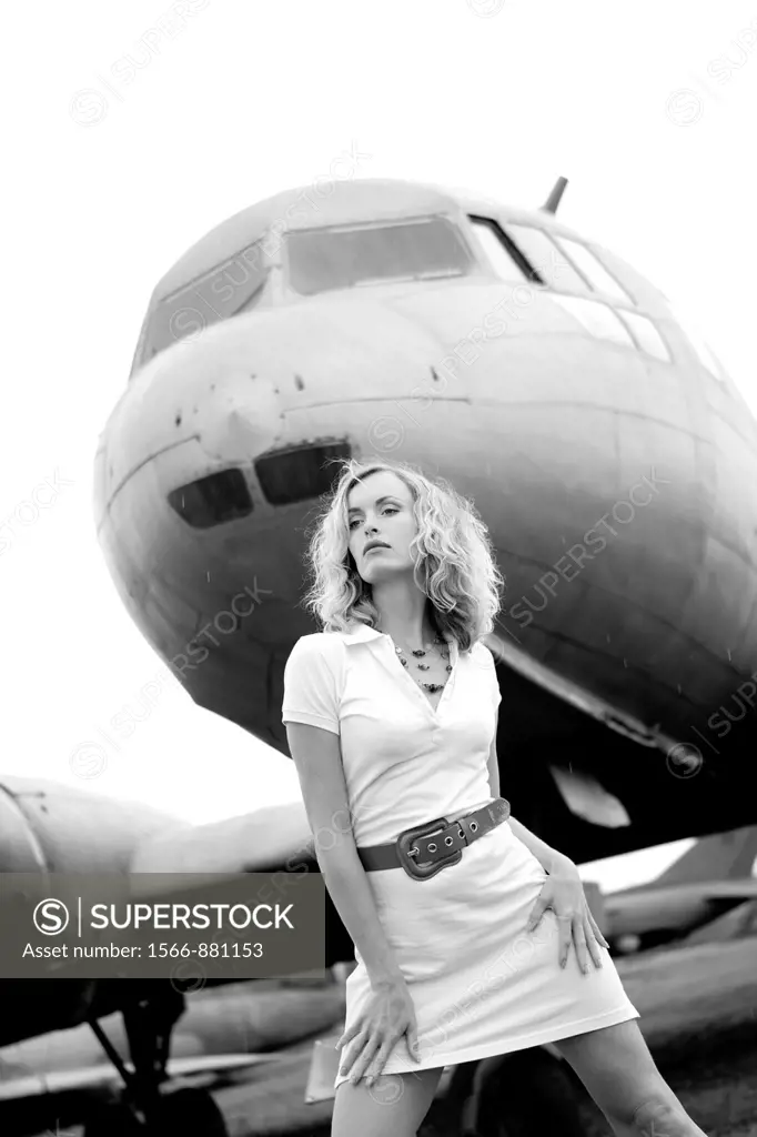 Sensual woman next to a plane