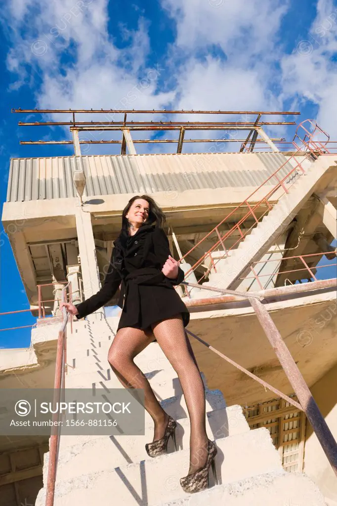 Sexy young woman in industrial environment