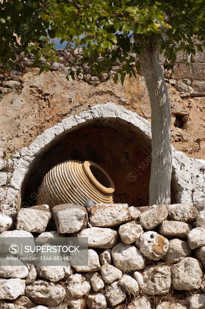 An old storage jar, pithari, and stone wall, Outer mani, Peloponnese, Southern Greece
