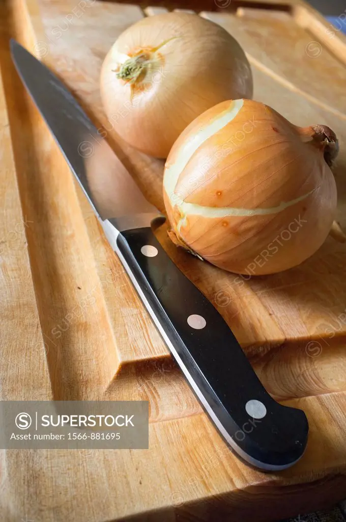 Two onion and knife on a cutting board