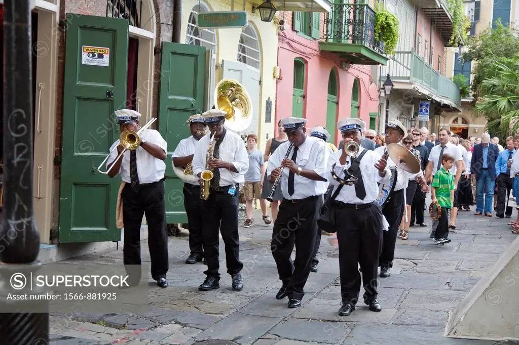 Paulin Brothers Brass Band playing music and leading a funeral procession in the French Quarter of New Orleans, LA