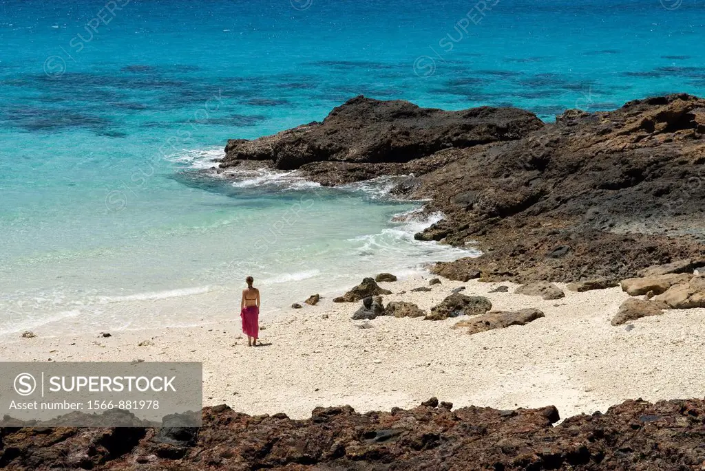 young woman walking on the beach, Tsarabanjina island, Mitsio archipelago, Republic of Madagascar, Indian Ocean