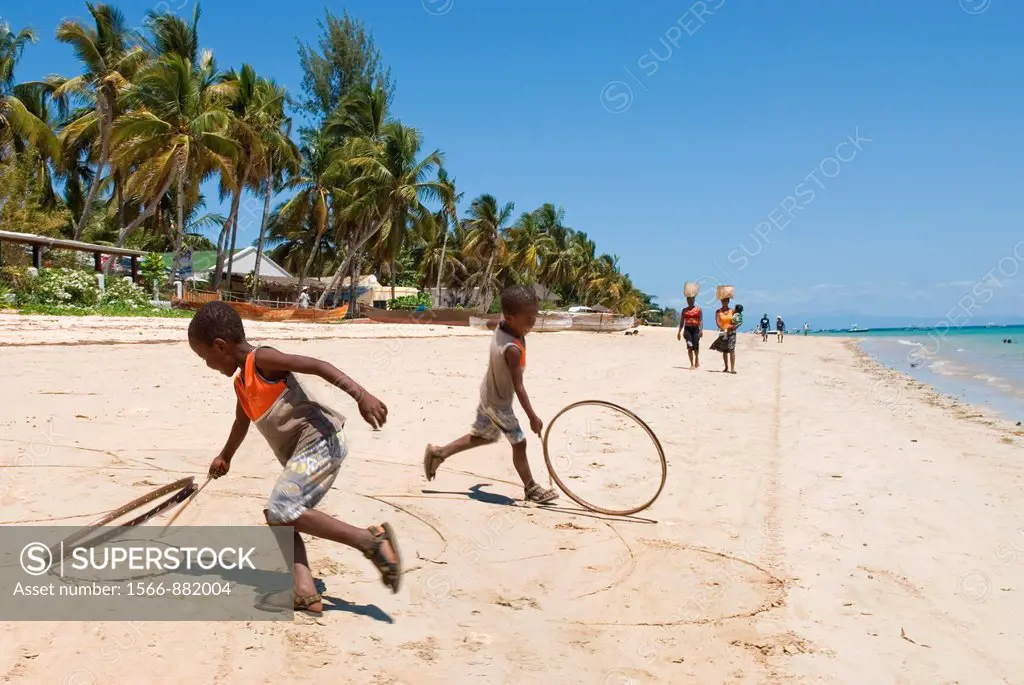 children playing on the beach of Ambatoloaka, Nosy Be island, Republic of Madagascar, Indian Ocean
