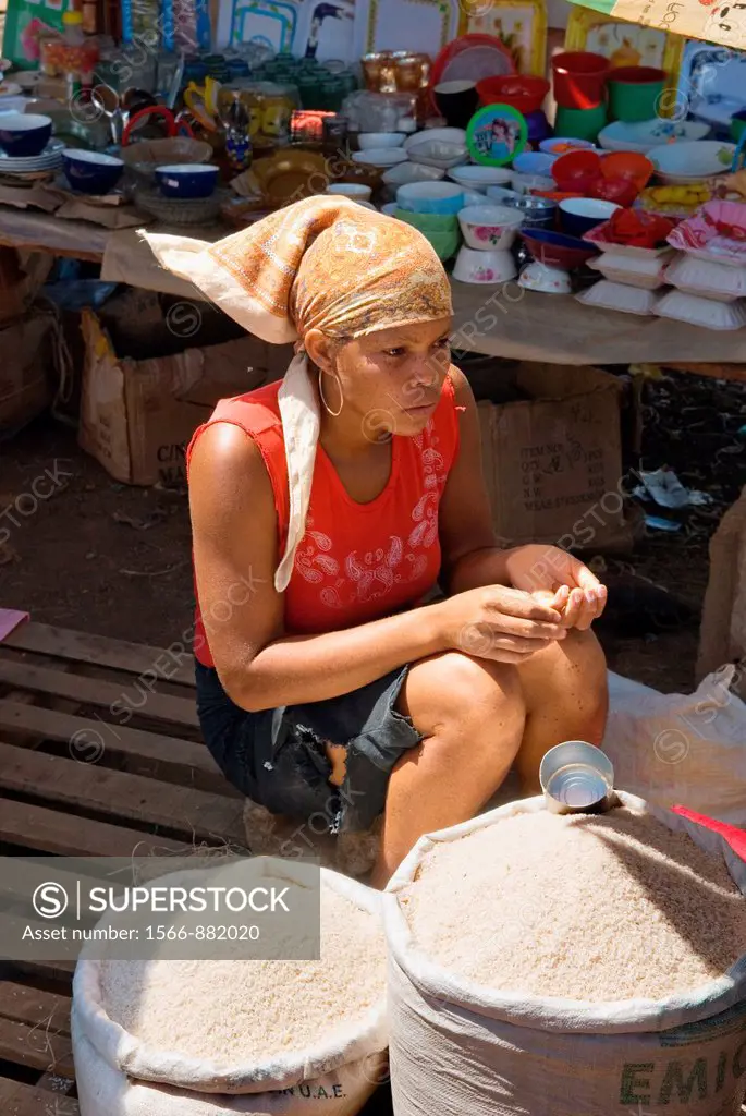 young saleswoman at the big market on the harbour, Hell-Ville Andoany, Nosy Be island, Republic of Madagascar, Indian Ocean