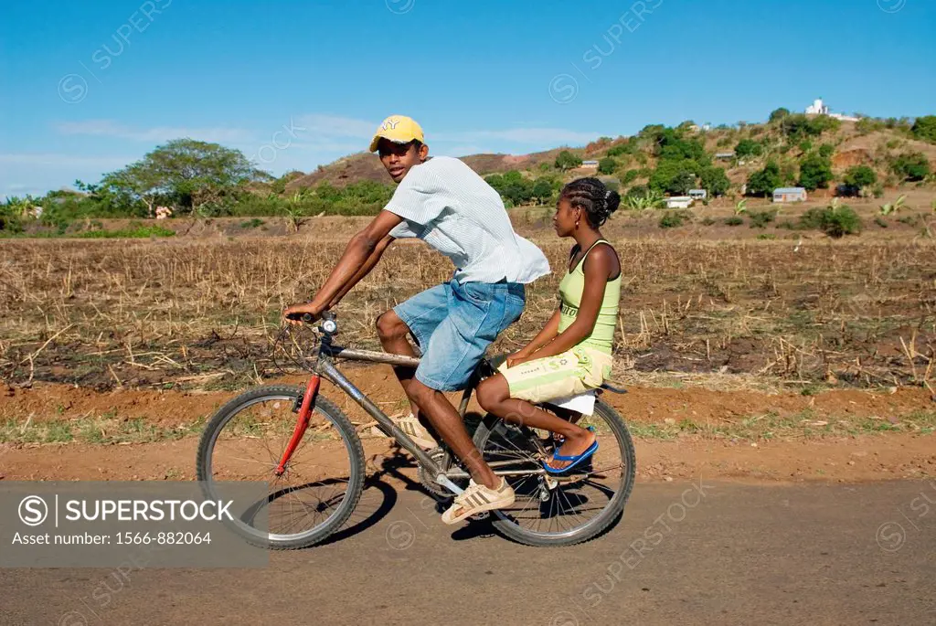 couple riding bicycle, Nosy Be island, Republic of Madagascar, Indian Ocean