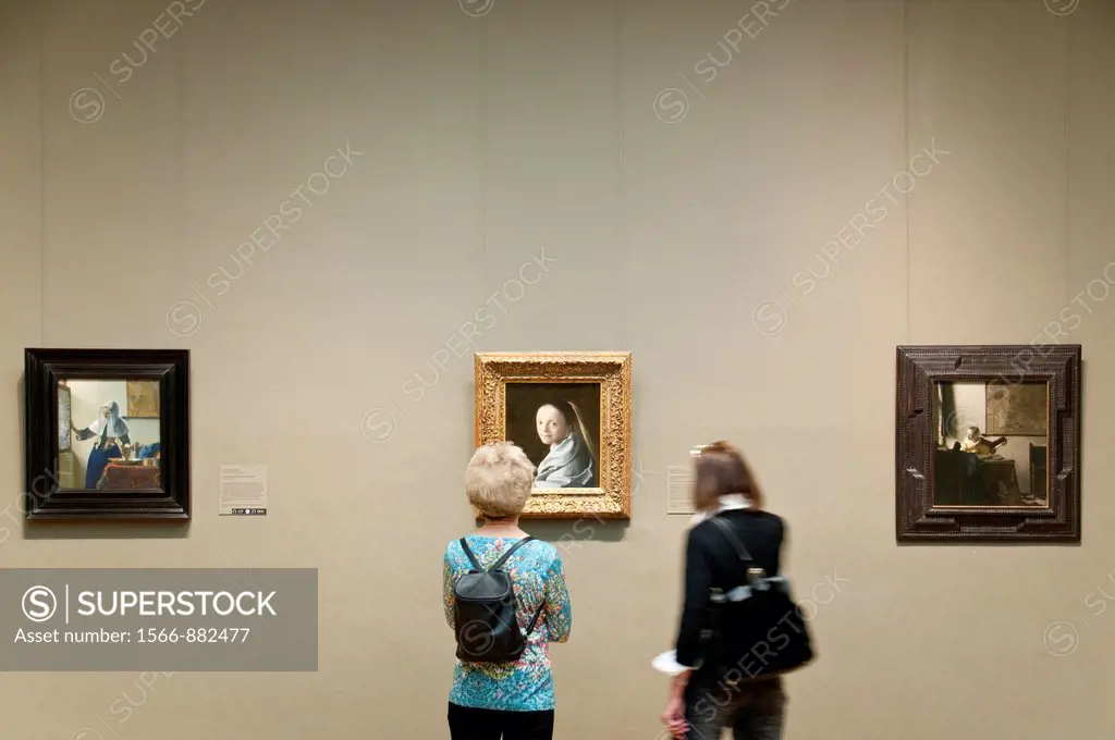 Museum visitors looking at Study of a Young Woman, ca 1665-67, by Johannes Vermeer, Metropolitan Museum of Art, New York City,