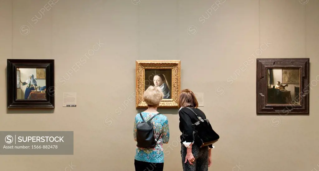 Museum visitors looking at Study of a Young Woman, ca 1665-67, by Johannes Vermeer, Metropolitan Museum of Art, New York City,