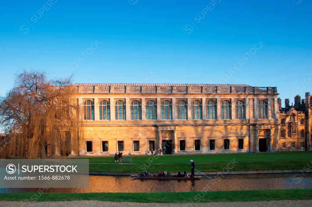 The Wren Library at sunset, Trinity College Cambridge, with punting in front on the river Cam, UK