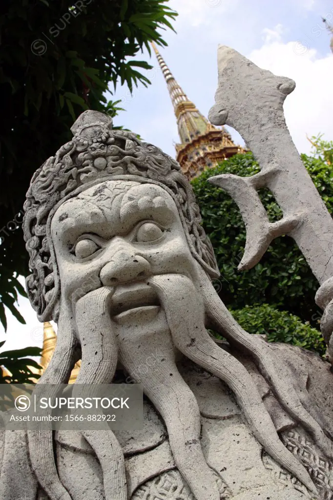 Stone statue in the courtyard of the Grand Palace, with the Phra Sri Rattana Chedi in the background, Bangkok, Thailand