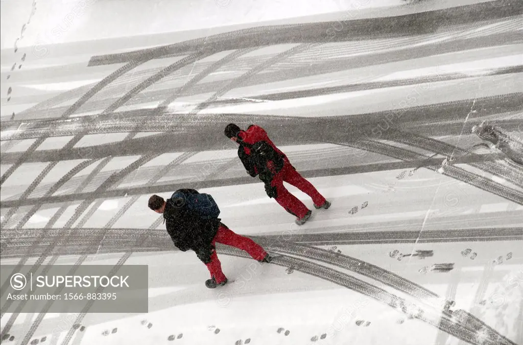 two men walking down snowed street, winter, Geneva, Switzerland
