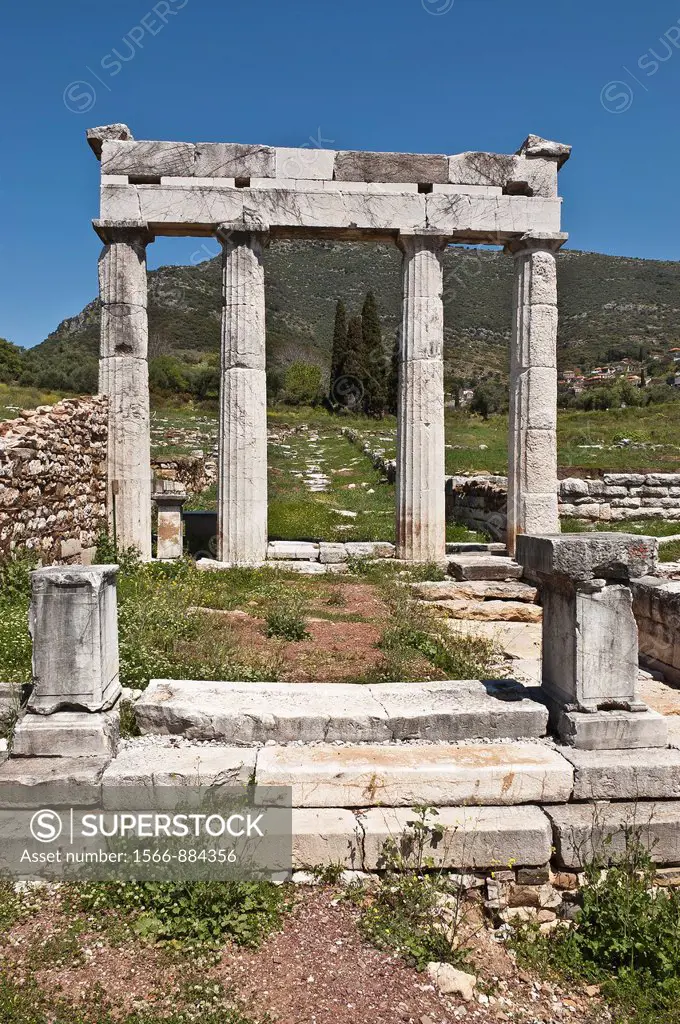 A columned entrance way at Ancient Messene Ithomi with the modern village of Mavromati in the background, Messinia, Southern Peloponnese, Greece