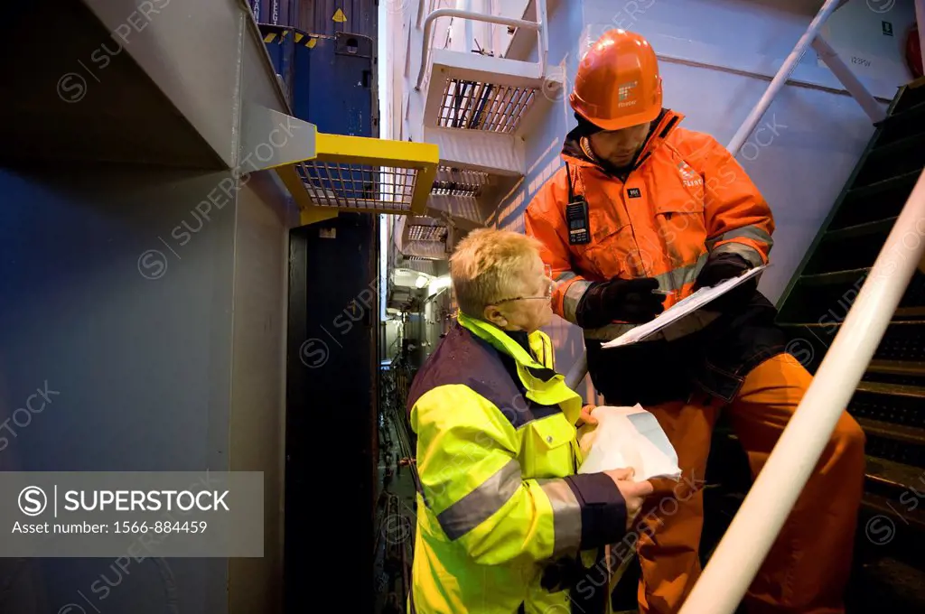 The second officer and the loading master from the dock consult on where to place containers on the deck and in the hold of container-vessel MV Flinte...