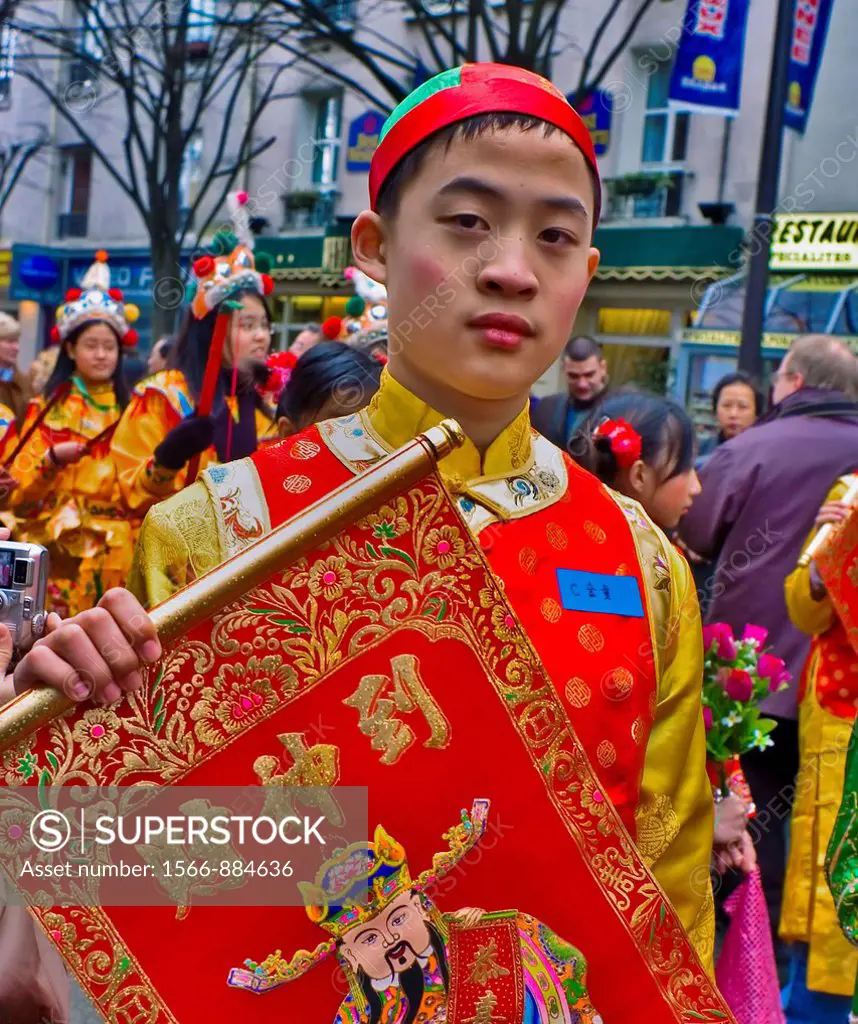 Paris, France, Street Scene, French-Chinese Male Teen in Traditional Costumes Parading in Chinese new years Carnival in Street in the Chinatown Area