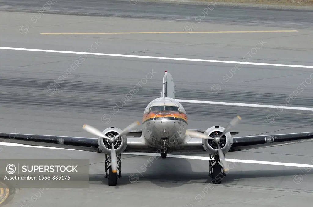 Old airplane Douglas DC-3 Dakota running on the taxiway, Anchorage, Alaska, USA