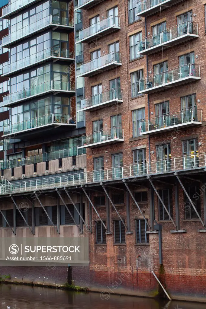 England, Greater Manchester, Manchester  Detail shot of modern apartments formed by redevolping Victorian warehouses located on the banks of the River...