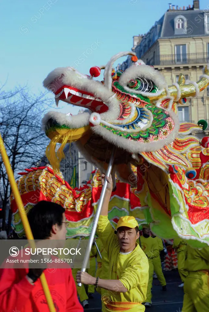 Paris, France, Chinese Man Doing Traditional Dragon Dance, Chinese new year Carnival in Street, in the Marais District
