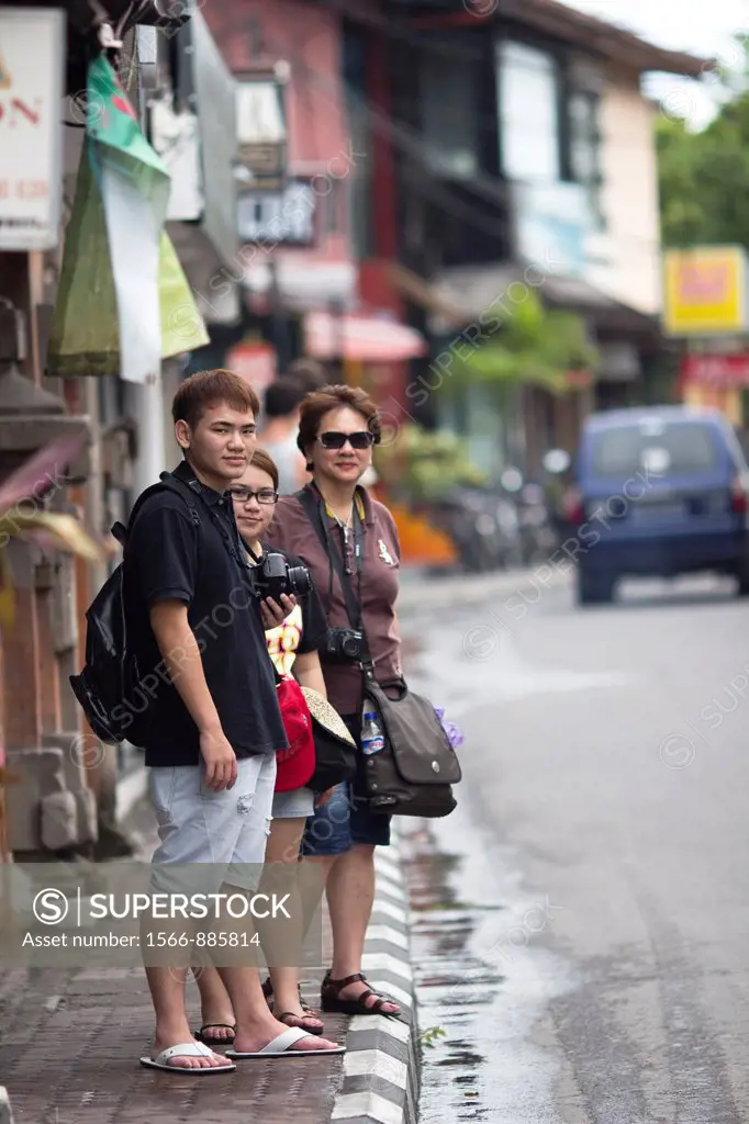 Tourists strolling shop houses at Seminyak Road, Bali