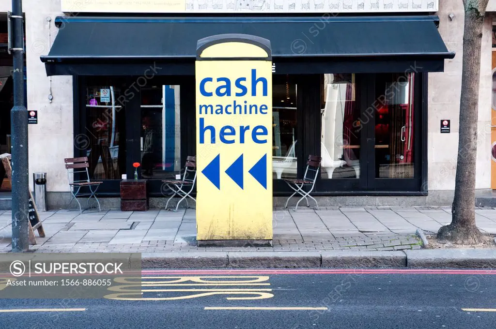 Cash machine banner in a public telephone box.