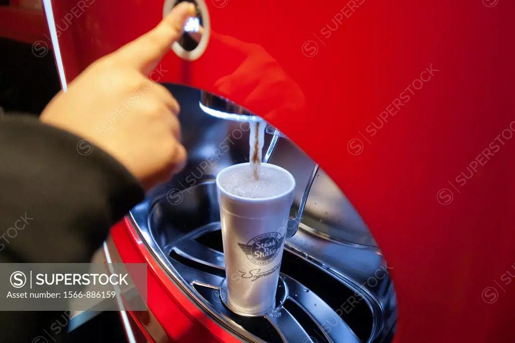 Customer uses self-service drink machine at the new Steak ´n Shake Signature restaurant in New York on its grand opening day, Thursday, January 12, 20...