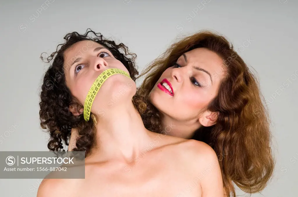 Eating disorder - a woman´s mouth is gagged with a tape measure implying the affect of body image on Anorexia and other eating disorders