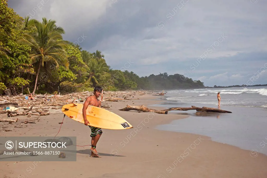 surfer at Playa Grande, a long sandy beach near Montezuma, Nicoya Peninsula, Costa Rica, Central America