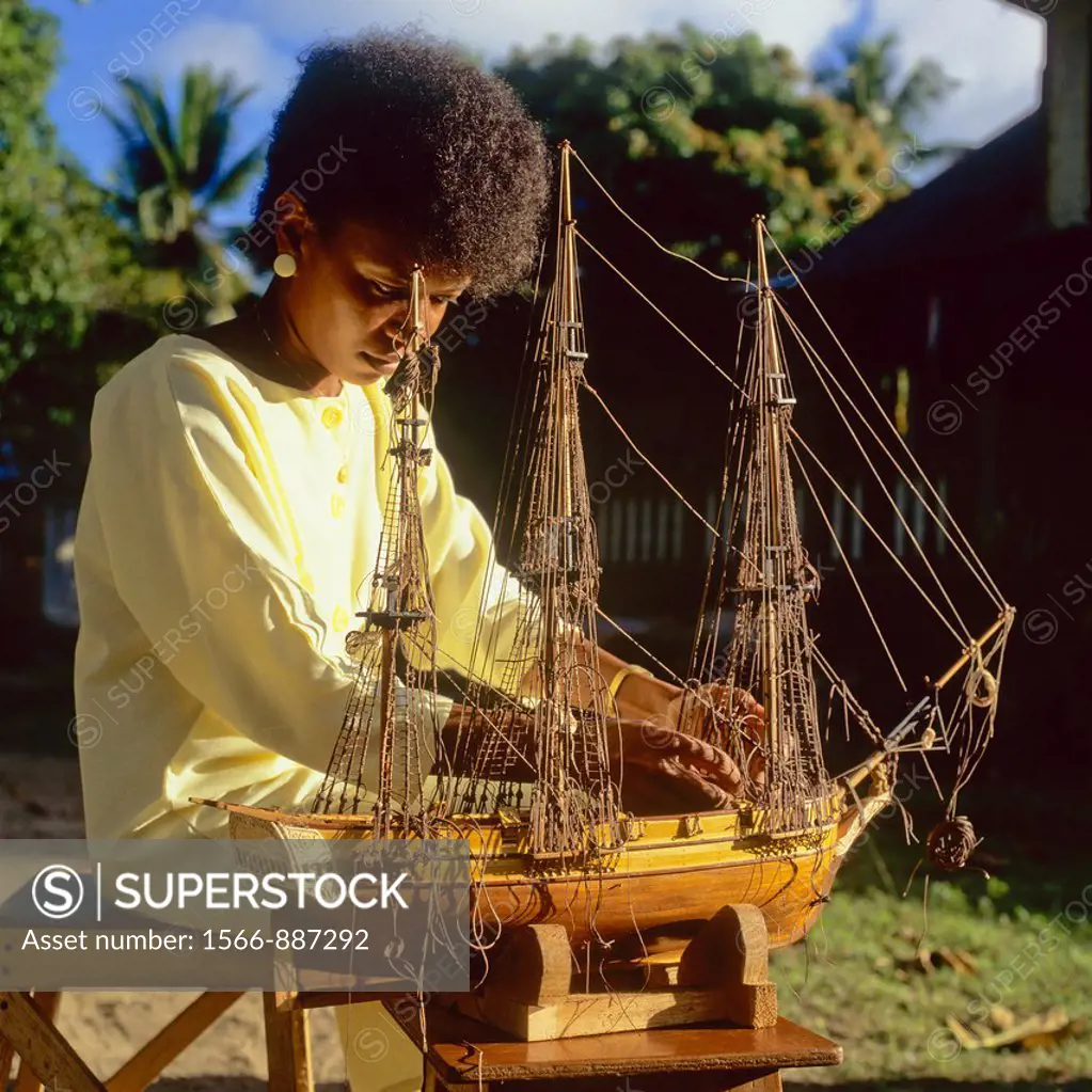 Woman making model sailboat, Mahé Island, Seychelles