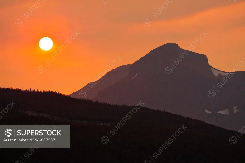 Sun setting through haze of wildfire near Two Medicine area of Glacier National Park in Montana