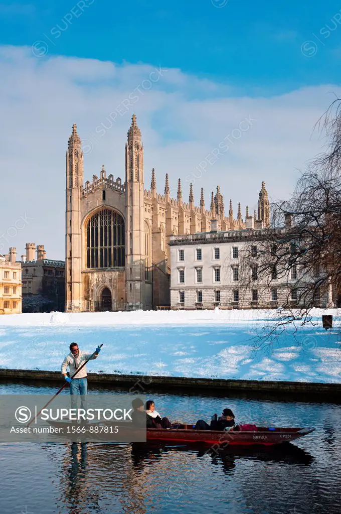 Punting along river Cam in winter snow with Kings College Chapel to the rear  Cambridge, England