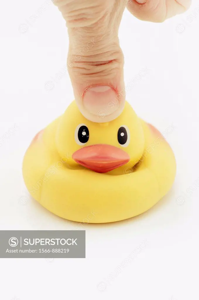 Thumb pressing on head of rubber duck