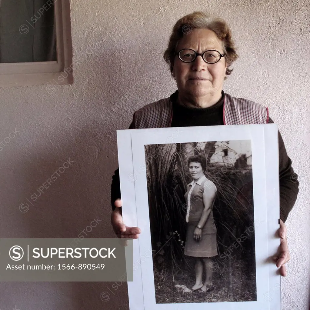 Woman showing old portrait in Valtuilla de Arriba, Leon province  Spain  The WAY OF SAINT JAMES or CAMINO DE SANTIAGO following the French Route, betw...