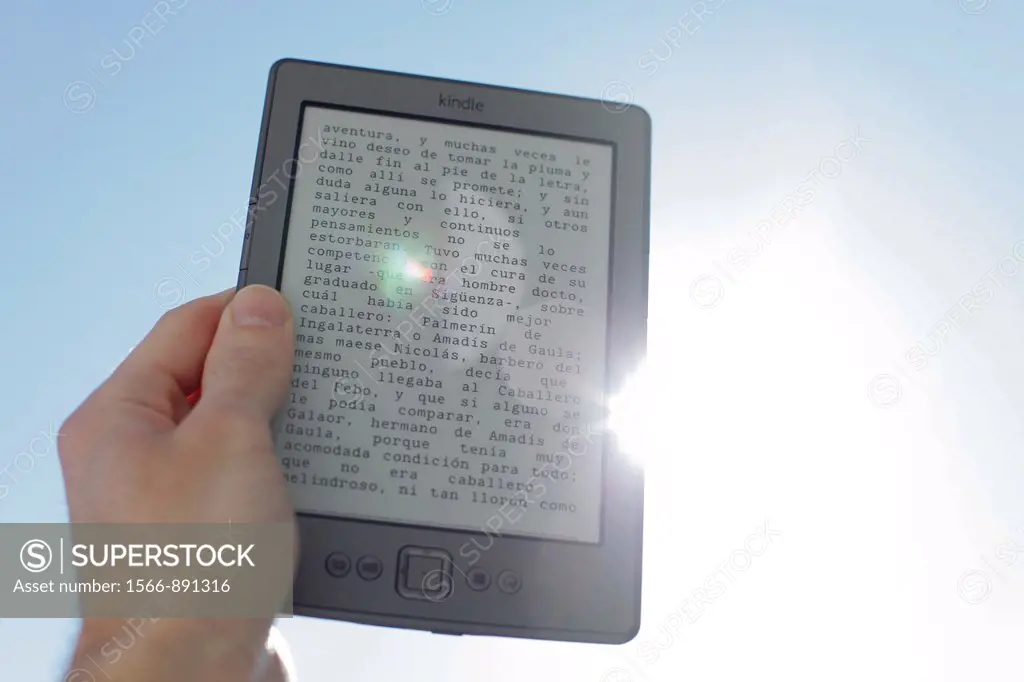 Kindle ebook reader pictured against sun