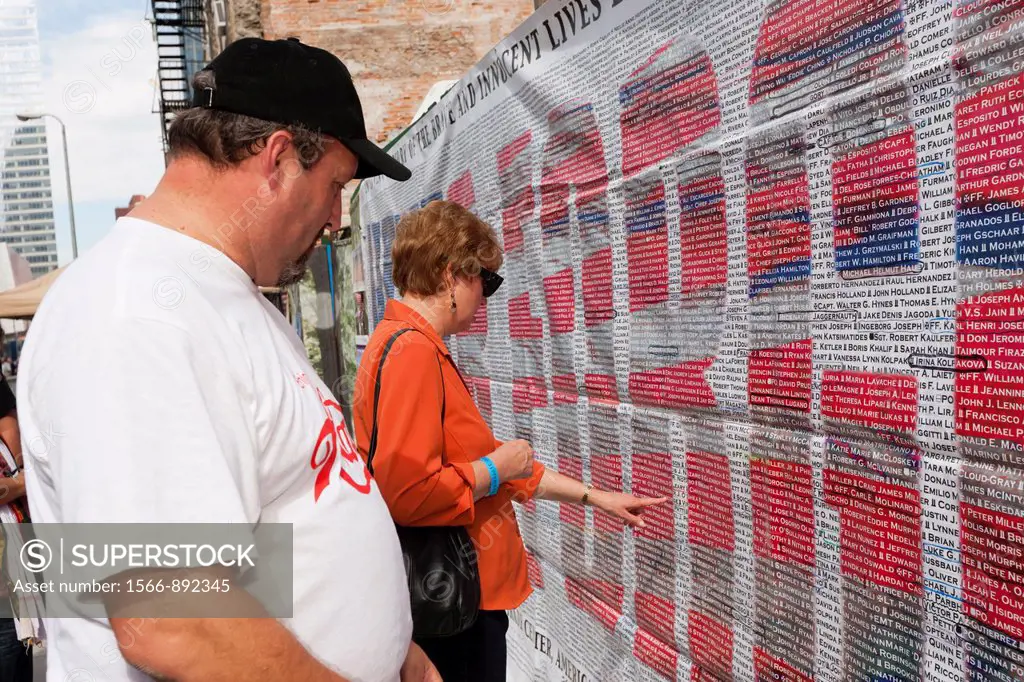 Visitors search for names on the list of those who perished in the 9/11 terrorist attack of the World Trade Center. The list is posted on Greenwich St...