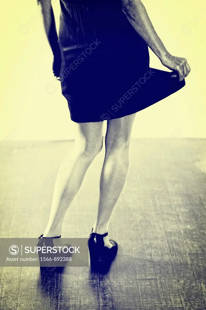 Woman in black dress swings her skirt