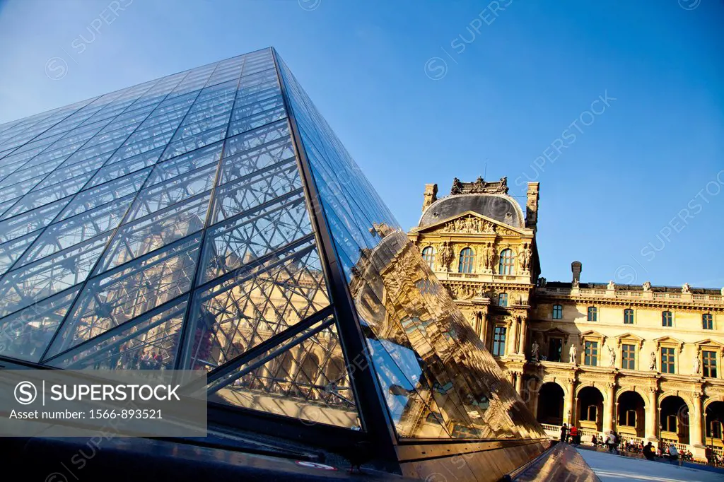 Glass pyramid entrance in front, Palais du Louvre or Louvre Palace museum in the evening light, Paris, France, Europe