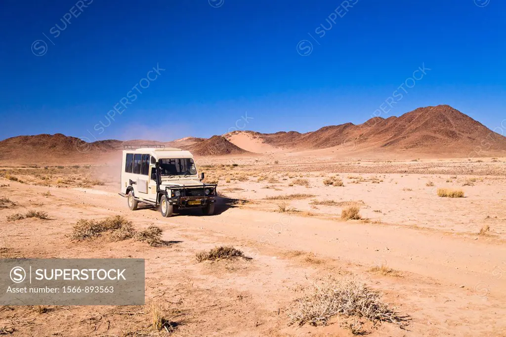 A landrover driving through the desert in Namibia, Africa