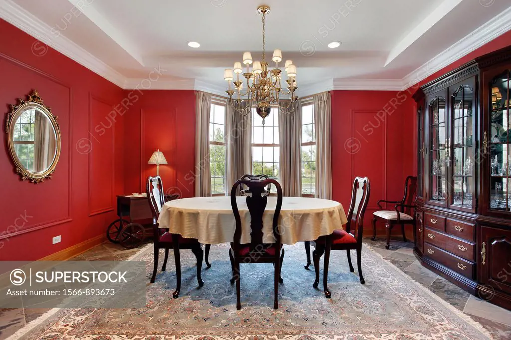 Dining room in luxury home with red walls