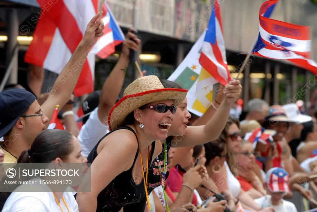 Spectators watch the 13th Annual National Puerto Rican Day Parade in New York on Fifth Avenue