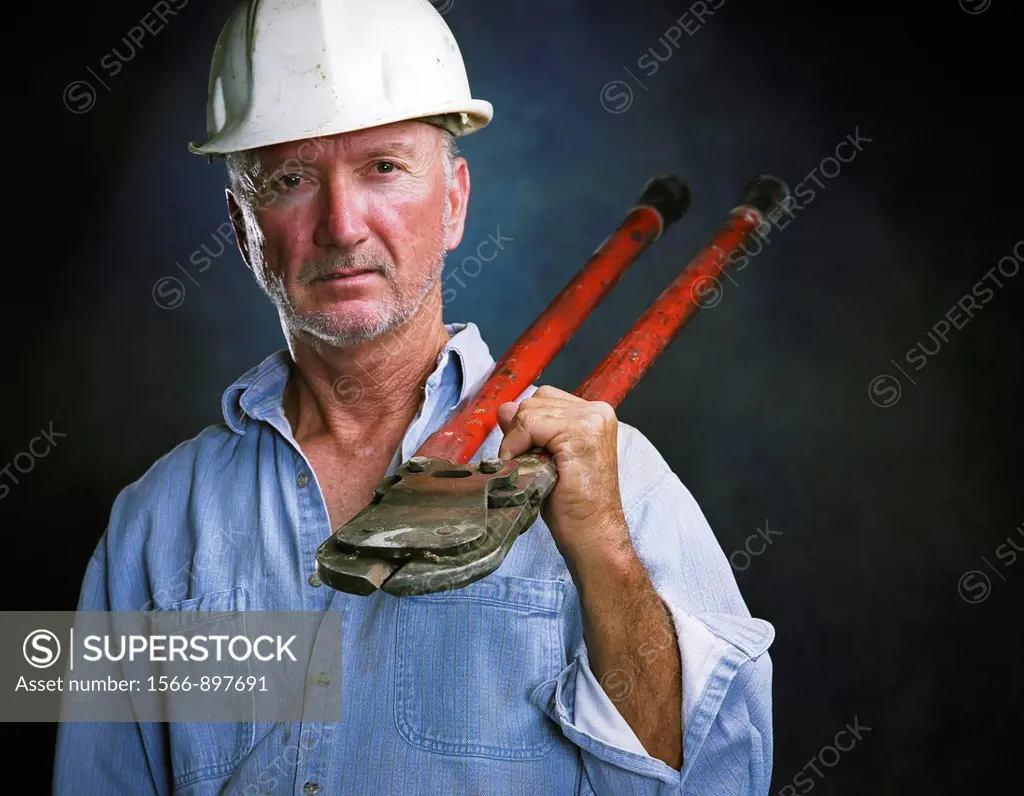 Middle-aged laborer holding bold cutters