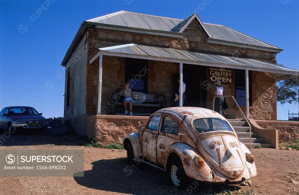 Old Beetle in front of Old House